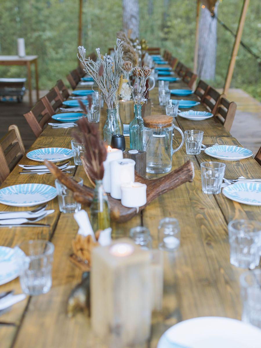 Rustic outdoor wedding breakfast table under canvas